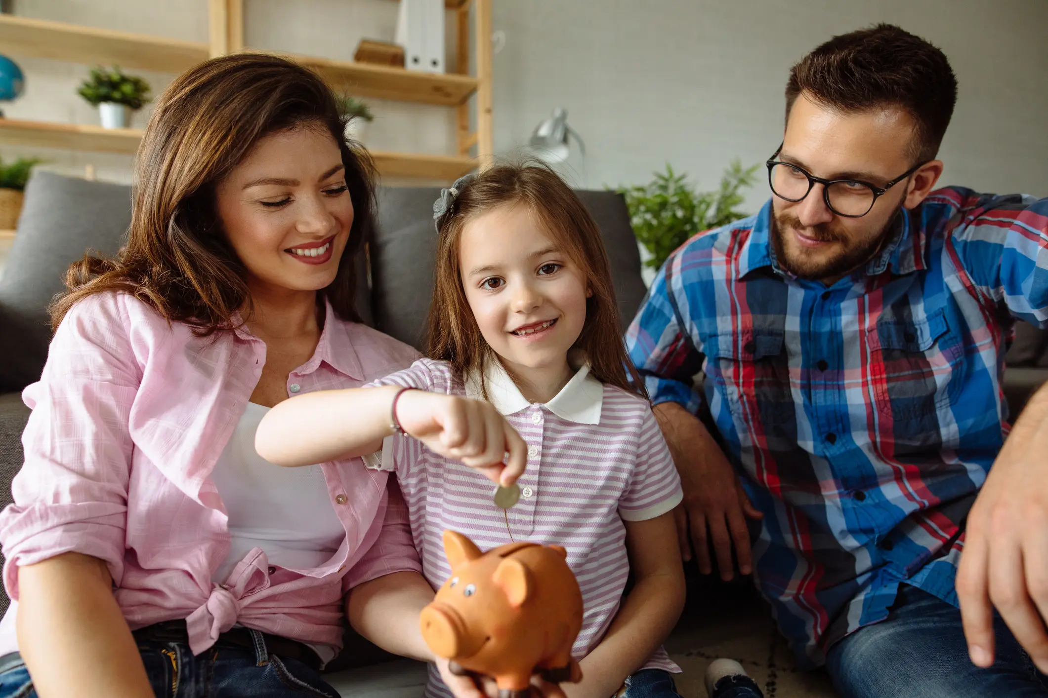 Portrait of a family saving money in piggybank