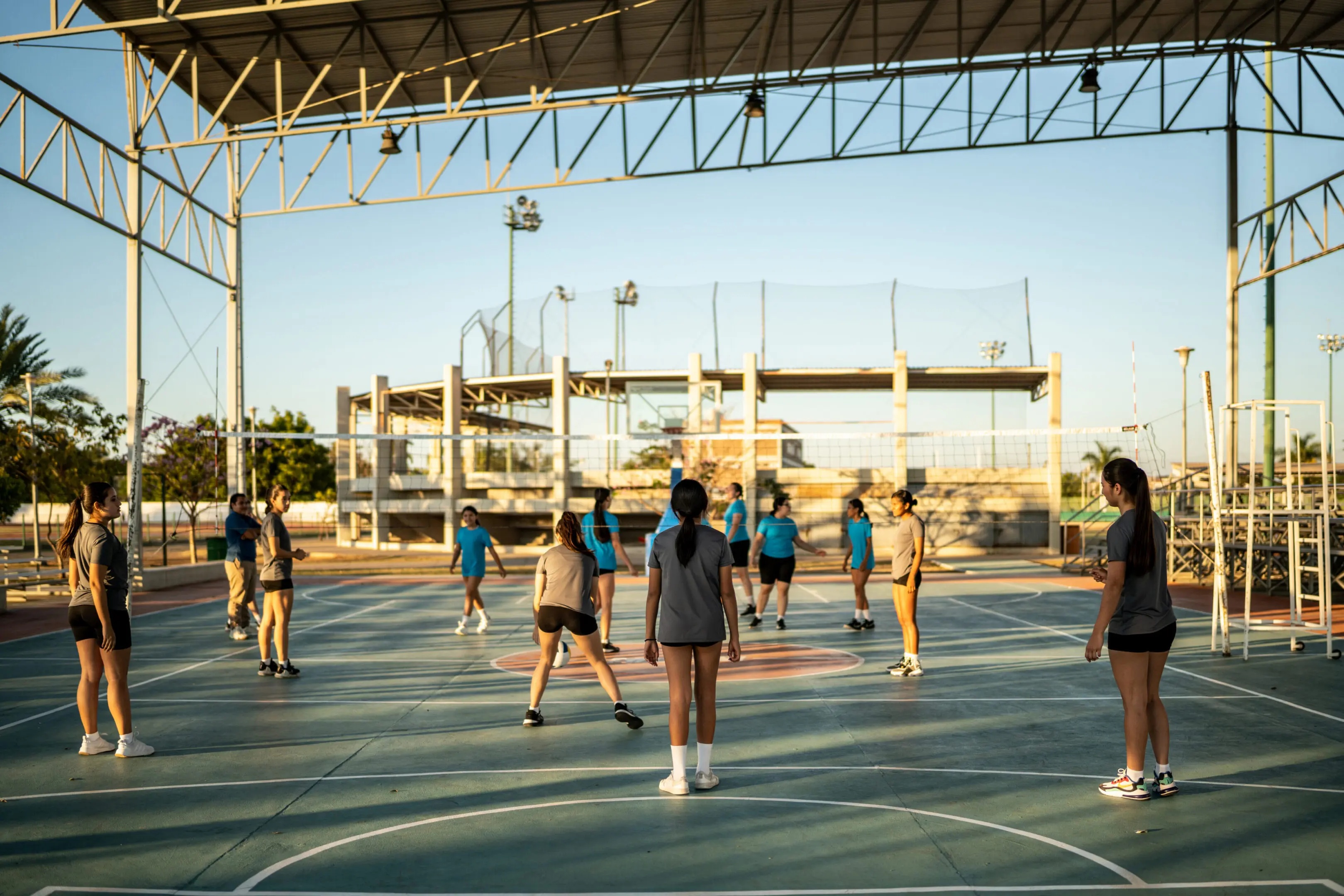 Female volleyball payers playing at sports court