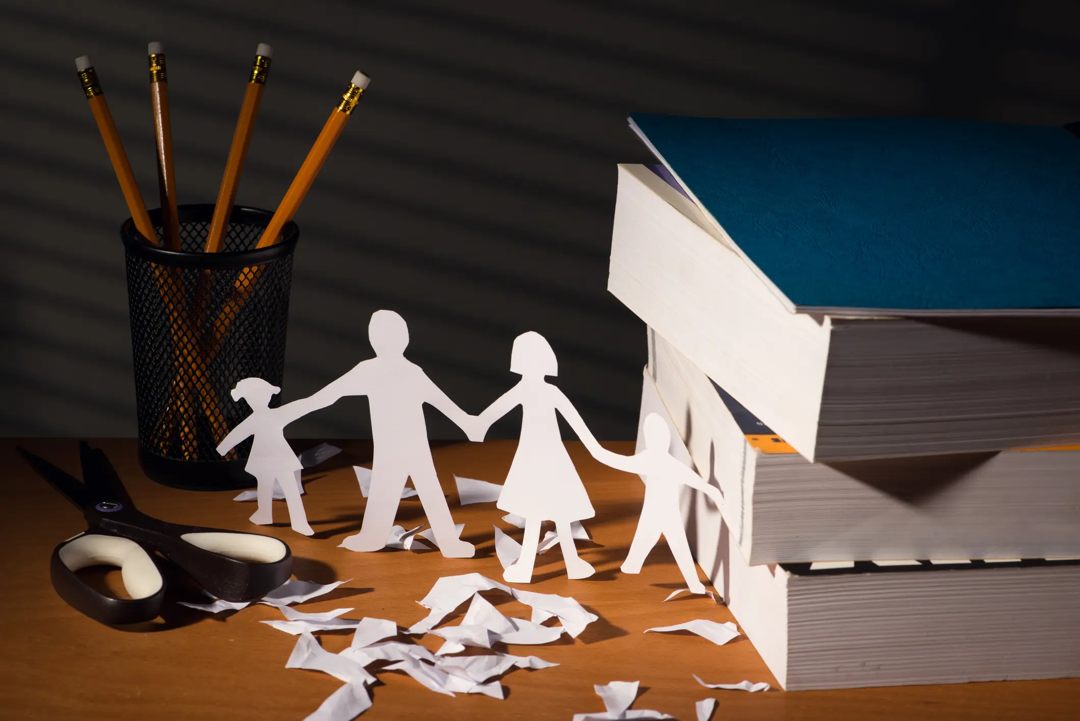 Desk with family in paper in night with light of blinds